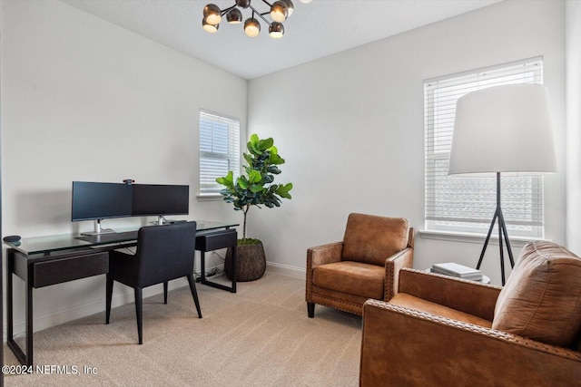 carpeted home office with a wealth of natural light and an inviting chandelier