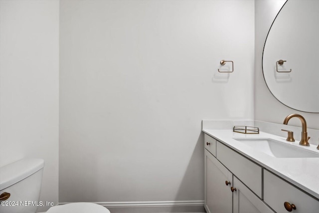 bathroom featuring toilet and vanity