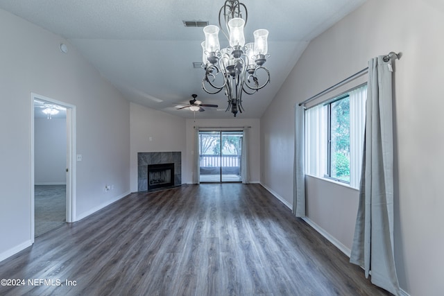 unfurnished living room featuring ceiling fan with notable chandelier, lofted ceiling, a wealth of natural light, and a tile fireplace