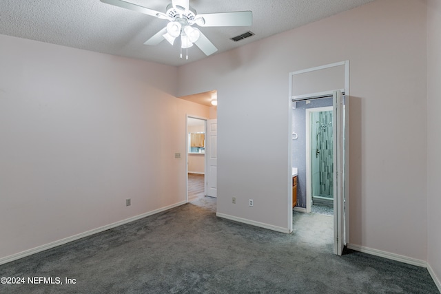 unfurnished bedroom featuring ceiling fan, a textured ceiling, and dark colored carpet