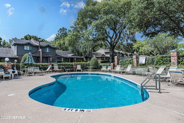 view of swimming pool with a patio