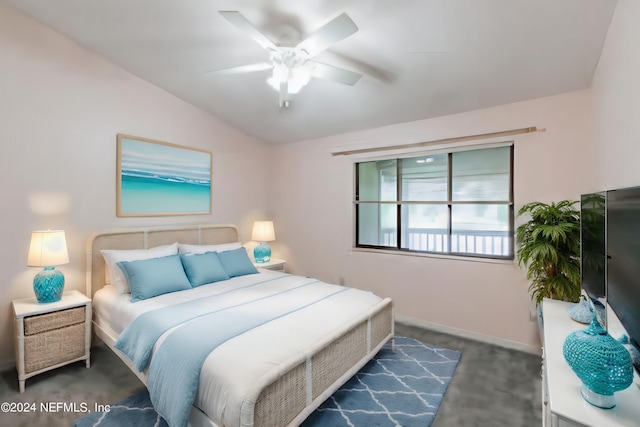 carpeted bedroom featuring ceiling fan and vaulted ceiling