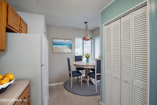 kitchen featuring pendant lighting and white fridge