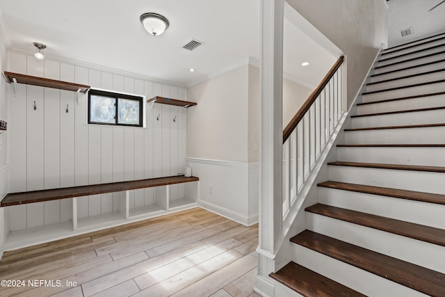 mudroom featuring light hardwood / wood-style floors and crown molding