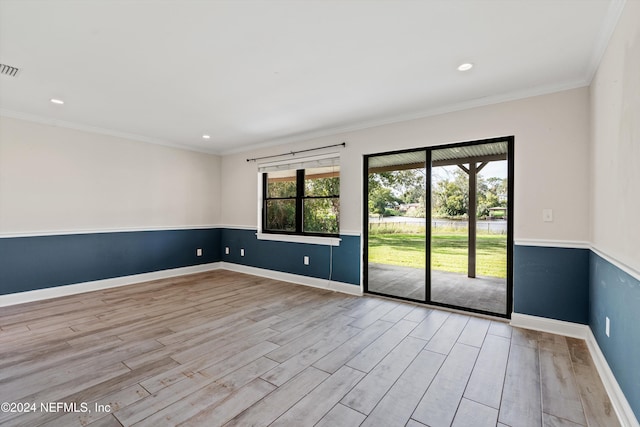 unfurnished room featuring light hardwood / wood-style floors and crown molding