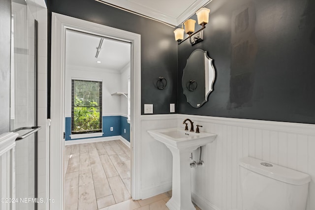 bathroom with toilet, hardwood / wood-style floors, and ornamental molding