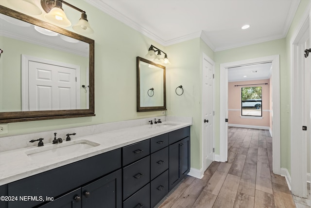 bathroom with vanity, ornamental molding, and hardwood / wood-style flooring