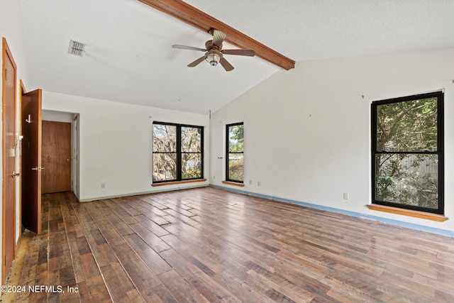 unfurnished room featuring beamed ceiling, a textured ceiling, dark hardwood / wood-style floors, and ceiling fan