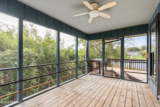 unfurnished sunroom with ceiling fan and plenty of natural light