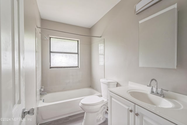 full bathroom with vanity, toilet, hardwood / wood-style floors, and tiled shower / bath