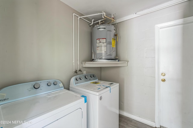 laundry room with independent washer and dryer, electric water heater, and dark hardwood / wood-style floors