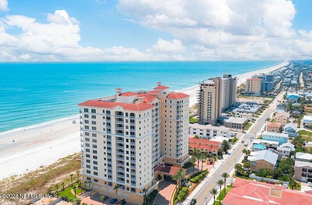 bird's eye view with a water view and a beach view