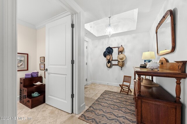 bathroom featuring crown molding and an inviting chandelier