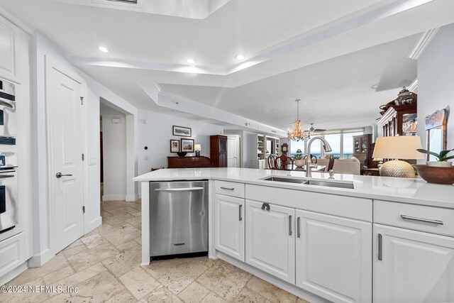 kitchen with a notable chandelier, white cabinetry, sink, and appliances with stainless steel finishes