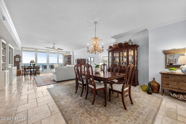 dining room featuring a textured ceiling, ceiling fan with notable chandelier, and ornamental molding