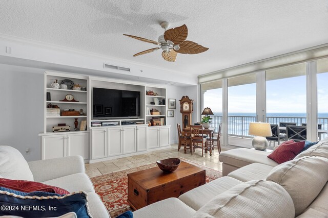 living room featuring ceiling fan and a textured ceiling