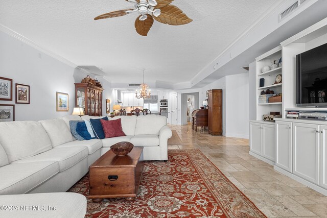 living room with ceiling fan with notable chandelier, ornamental molding, and a textured ceiling