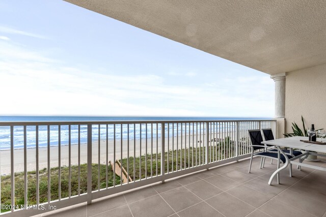 balcony with a view of the beach and a water view