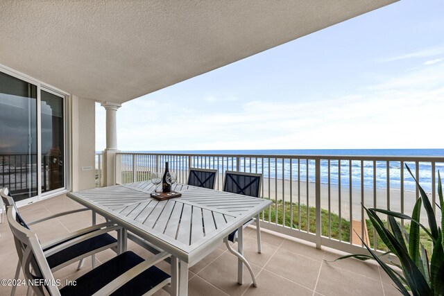 balcony with a beach view and a water view