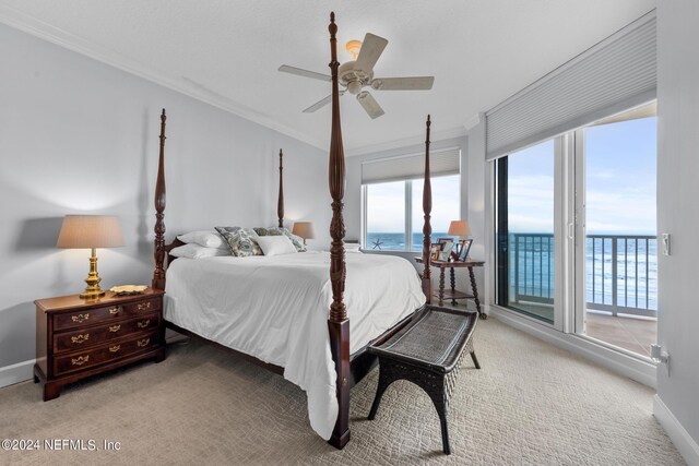 bedroom featuring access to exterior, ceiling fan, crown molding, a water view, and carpet