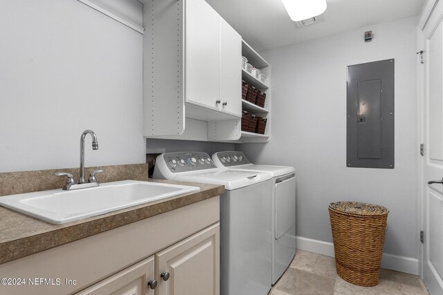 laundry area with cabinets, sink, electric panel, and washing machine and clothes dryer