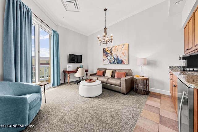 living room featuring an inviting chandelier, beverage cooler, and ornamental molding