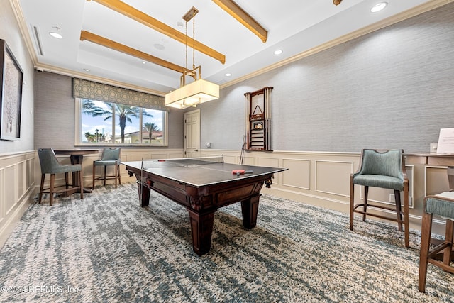 rec room featuring a raised ceiling, crown molding, and dark colored carpet