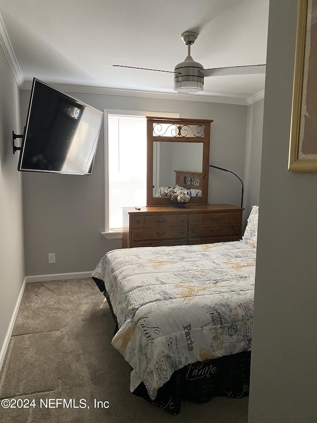 bedroom with ornamental molding, ceiling fan, and carpet floors