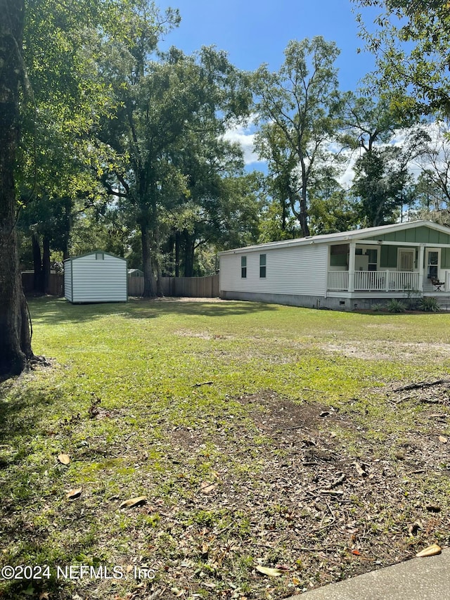 view of yard featuring a shed and covered porch