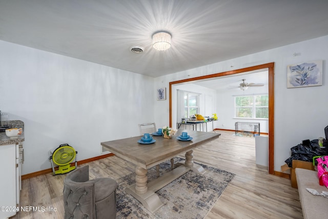 dining room with ceiling fan and light hardwood / wood-style flooring