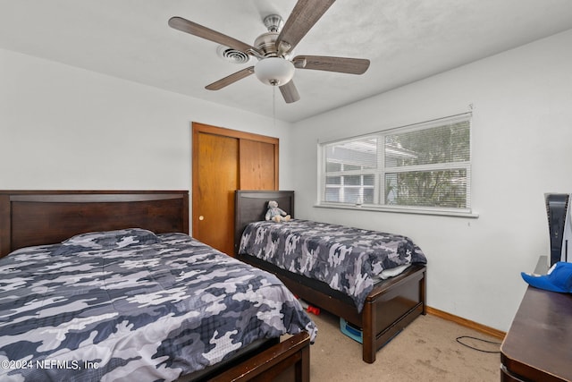 bedroom with ceiling fan and light carpet