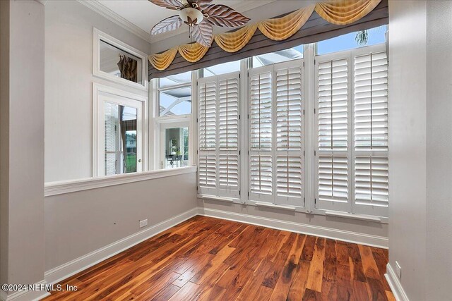 unfurnished room with ornamental molding and dark hardwood / wood-style flooring