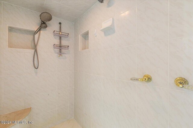 bathroom with tiled shower