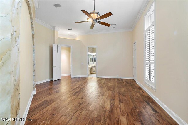 spare room with dark hardwood / wood-style flooring, crown molding, and ceiling fan