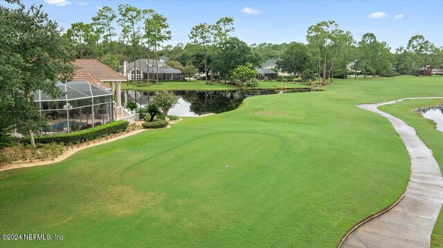 view of property's community with a yard and a water view