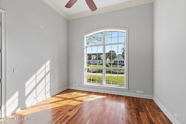 unfurnished room with dark wood-type flooring, ceiling fan, and crown molding