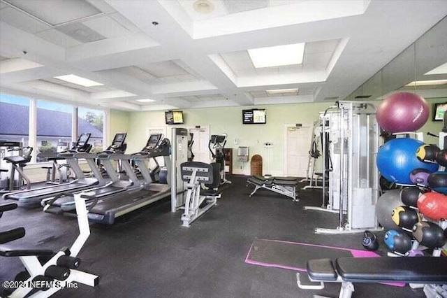 exercise room featuring coffered ceiling