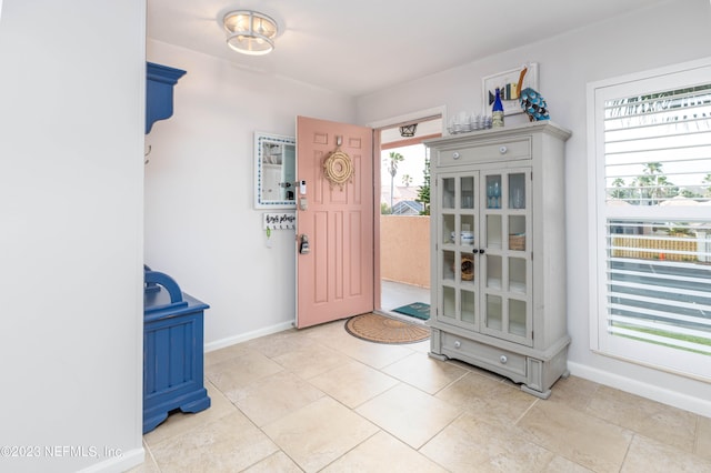 foyer featuring light tile patterned floors and plenty of natural light