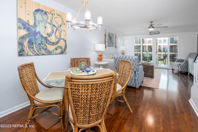 dining space featuring ceiling fan with notable chandelier and dark hardwood / wood-style floors