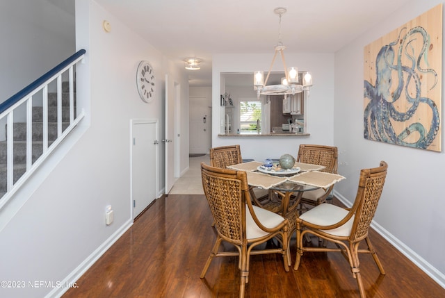 dining room featuring dark hardwood / wood-style floors and a chandelier