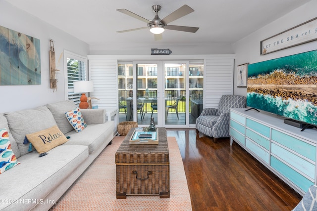 living room featuring ceiling fan and dark hardwood / wood-style flooring