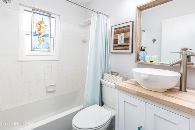 full bathroom with vanity, toilet, and shower / tub combo with curtain