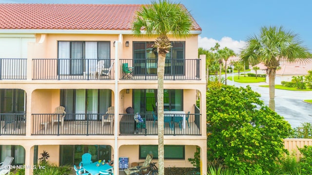 rear view of property with a balcony