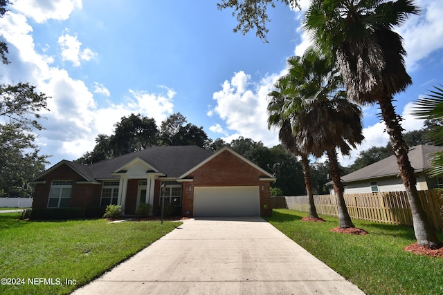 single story home with a front yard and a garage