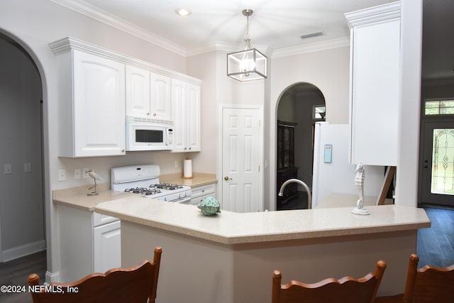 kitchen featuring crown molding, white cabinets, dark hardwood / wood-style floors, and white appliances