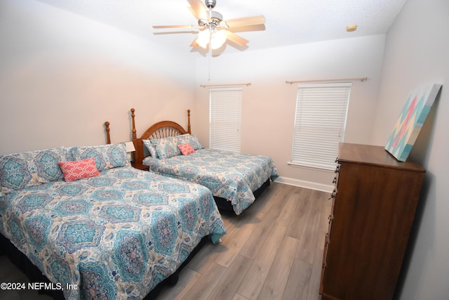 bedroom with ceiling fan and hardwood / wood-style flooring