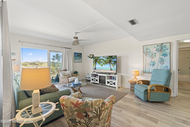 living room featuring ceiling fan and light hardwood / wood-style flooring