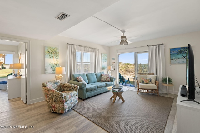 living room featuring light wood-type flooring and ceiling fan