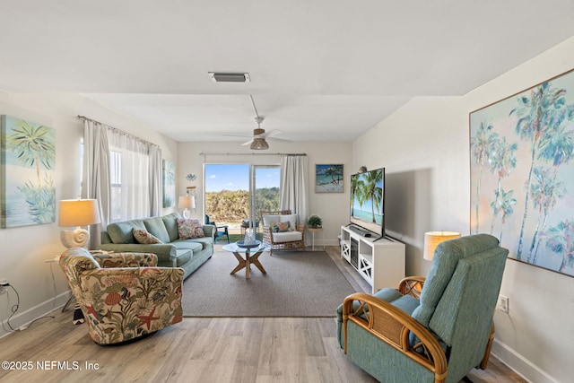 living room with light wood-type flooring and ceiling fan