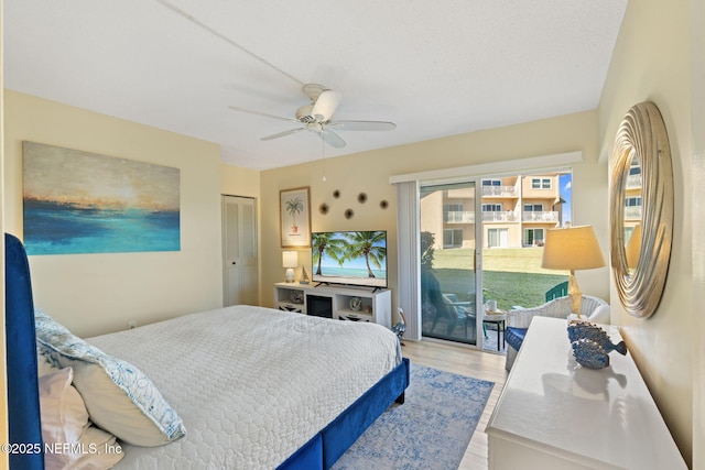 bedroom with access to exterior, ceiling fan, a closet, and light hardwood / wood-style flooring